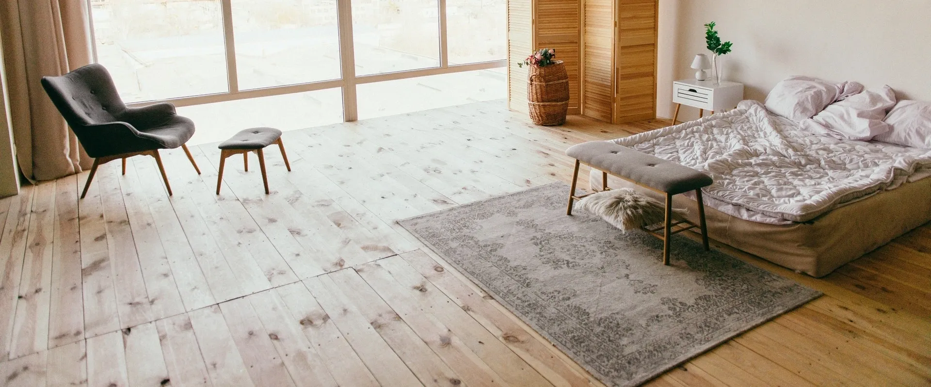 A room with wooden floors and a rug.
