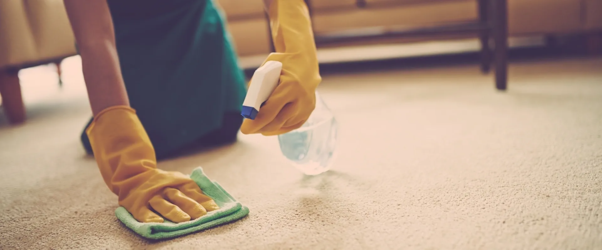 A person in yellow gloves holding a blue marker.